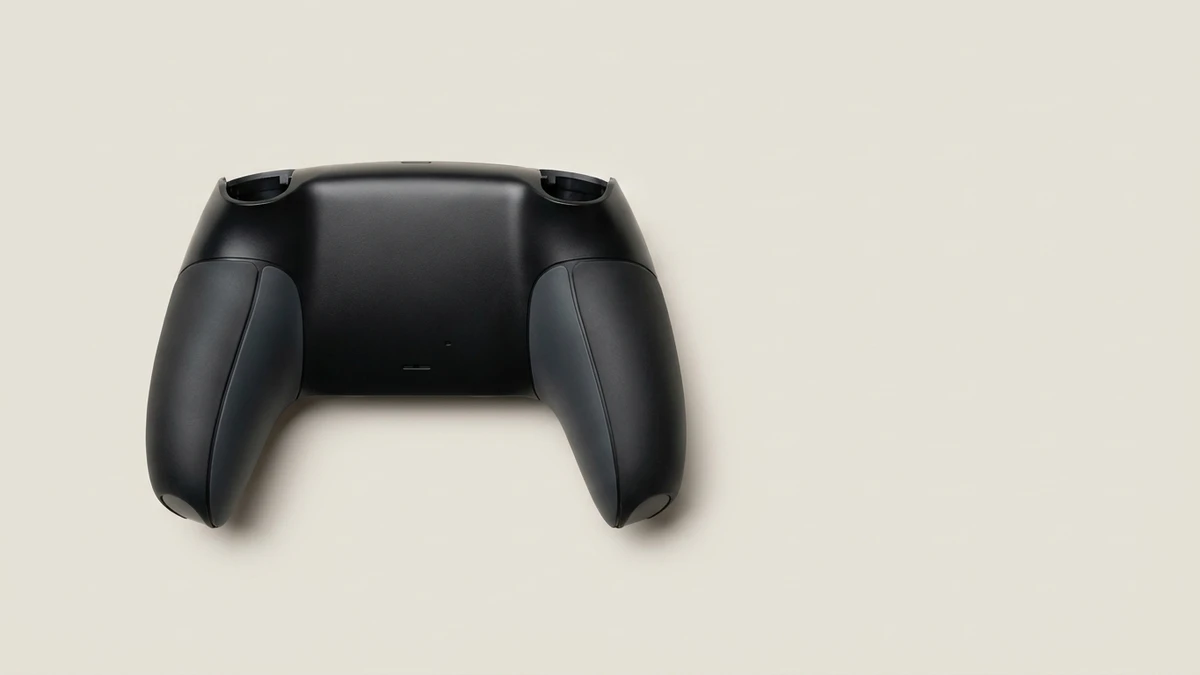 Hard-plastic game controller shell with left and right TPE grip zones and the hard-soft material boundary along the outer grip